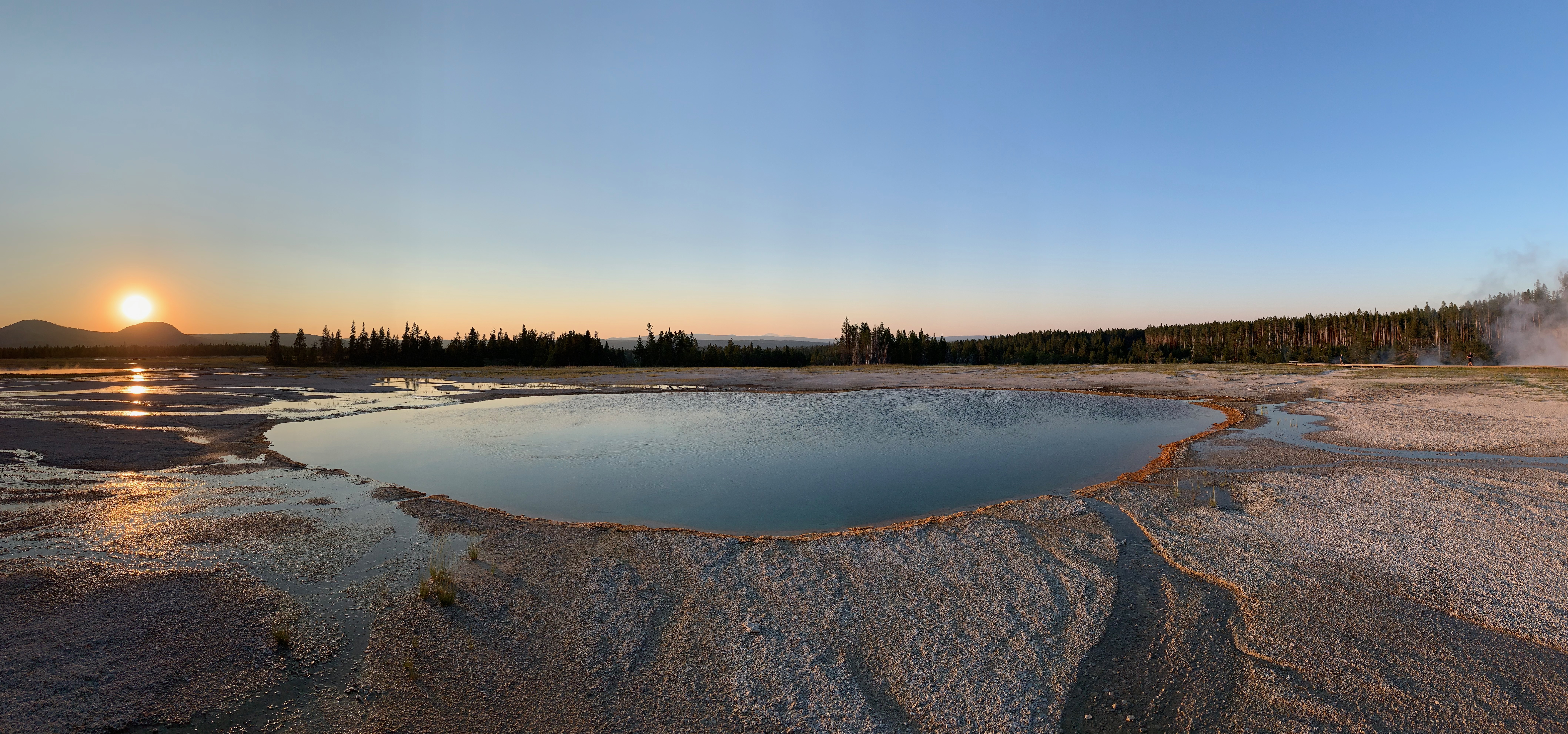 Sunset behind a geothermal pool